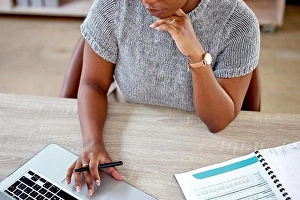 Zoom Prints: Getting the job done. a businesswoman working on her laptop