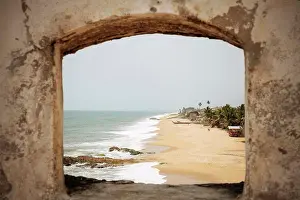 Fishing Village Prints: Ghana, Cape Coast, Beach and sea seen through stone arch
