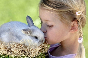 Bunny Prints: Girl (6-7) kissing Easter bunny, close-up, side view