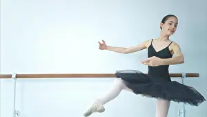 Talent Prints: A girl ballet student practices ballet dancing at home with a white background A girl ballet student practices ballet