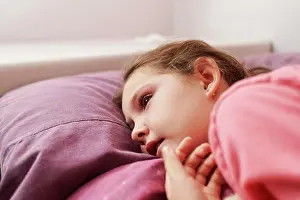 Relaxed Prints: Detail of a girl in bed looking thoughtfully at infinity