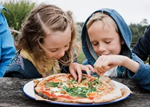 Lunch Prints: girl and boy sharing a pizza together at an outdoor restaurant