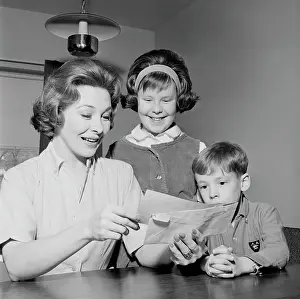 Side By Side Prints: Girl and boy are watching as cheerful mother is reading letter