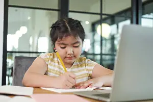 Video Prints: Girl children using laptop computer, studying through online