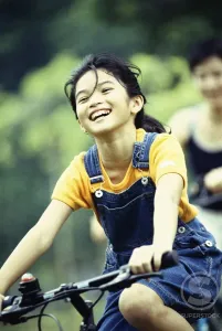 Overalls Prints: Girl cycling and smiling