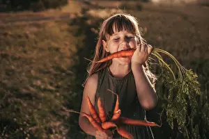 Gradeschooler Prints: girl eats carrots, harvest season, vegetables, vegetable garden