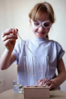 Student Prints: a girl in goggles conducts chemical experiments at home