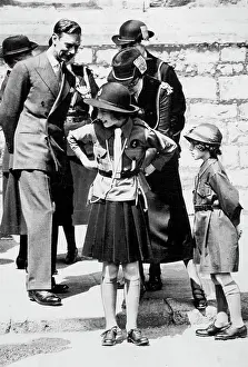 1938 Prints: Girl Guides Inspection At Windsor A charming incident during the March Past of the Girl Guides