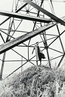 girl on the hall among electric line constructions. Autumn day
