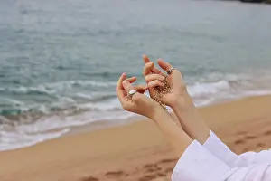Fingers Prints: Girl hands on the background of beach and sea