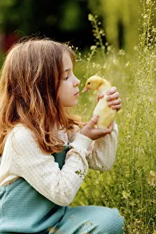 Unschuld Prints: Girl holding duckling in palms