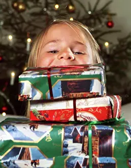 Holidays Prints: Girl looking out from pile of Christmas gifts