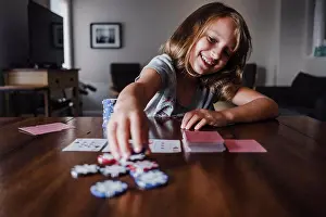 Amuse Prints: Girl playing cards at table, placing gambling chips