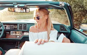 Autool Prints: Girl posing in a convertible Girl posing in a convertible on the camera