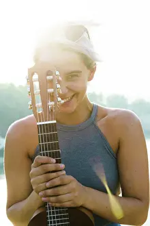 Instrument Prints: Girl posing with small guitar at street