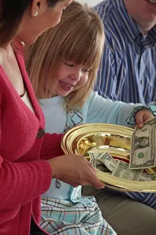 Father Prints: a girl putting money in the collection plate