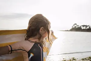 Sparkle Prints: girl running with towel at the beach watching the sunset