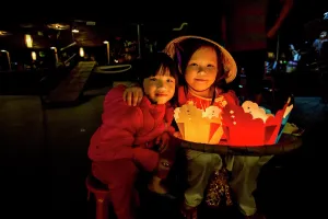 Selling Prints: Girl selling candle floats. Tet Festival, New Year celebration, Vietnam. (MR)