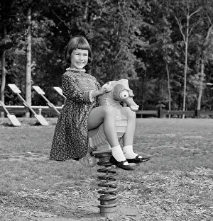4 5 Years Prints: Girl sitting on spring rider smiling