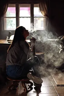 Freude Prints: The girl smoke electronic cigarette Girl smokes an electronic cigarette by the window