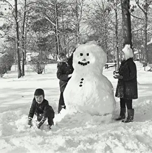 Snowman Prints: Two girls making a snowman