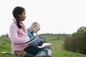 Notebook Prints: Two girls sketching on hillside