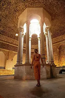 Mediaeval Prints: Girona medieval city, a young tourist in the interior of the Banys Arabs or Arab baths