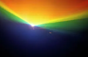 Worlds Prints: A glowing rainbow pattern of laser lights against a black background