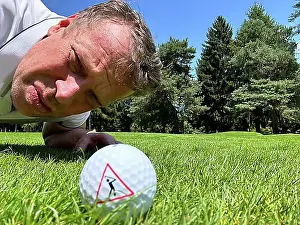 Inscription Prints: Golfer Looking at a Golf Ball with Warning Sign on the Fairway in a Sunny Day in Switzerland