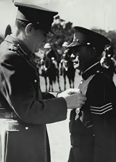 Police Prints: The governor lord Wakehard pinning king's police medal on breast of Sgt Tracker Alexander Relay