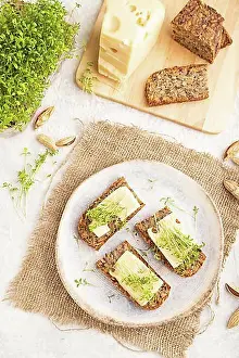 Cheese Prints: Grain bread sandwiches with cheese and watercress microgreen on gray concrete background and linen textile
