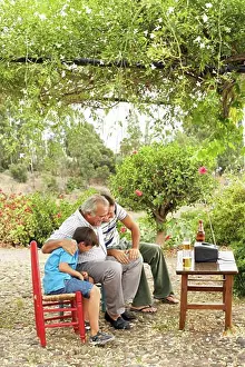 Unwind Prints: Grandfather, Father and Son Watching Television in Backyard