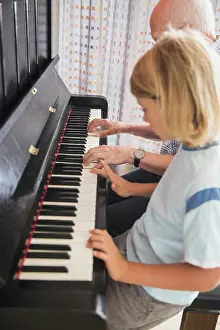 Grandfather Prints: Grandfather and grandson playing piano instrument
