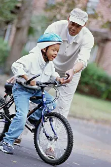 Grandfather Prints: Grandfather teaching his grandson ride a bicycle