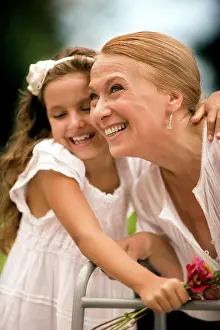 Handicapped Prints: Grandmother and her granddaughter laugh together holding a bunch of flowers