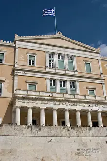 Greece Prints: Greece, Athens. Greek Parliament building with Greek flag behind Tomb of the Unknown Soldier