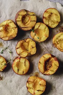 Lunch Prints: Grilled peaches and nectarines halved on baking paper sheet with thyme