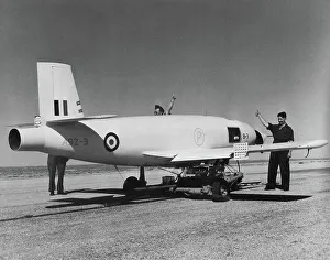 A ground crew gives the thumbs up (she's ready) sign to ***** a Jindivik pilotless