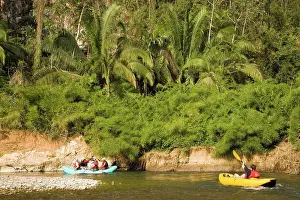 Group Of People Prints: A group of adventure tourists rafting and kayaking on Caves Branch River in Central Belize