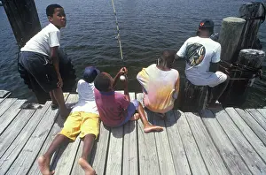 Florida Prints: Group of African-American children fishing off dock, Ft. Myers, FL