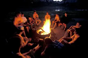 Montana Prints: A group of boy scouts sits around a campfire while camping