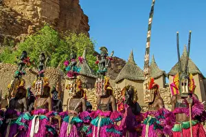West Africa Prints: A group of Dogon dancers in traditional costumes in a Dogon village at the Bandiagara Escarpment in the Dogon country