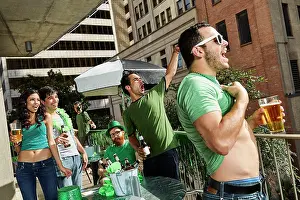 Macho Prints: Group of friends hanging out on balcony of bar enjoying the St Patrick's Day festivities