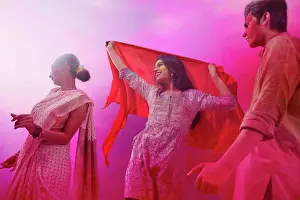Holi Prints: A GROUP OF FRIENDS HAPPILY DANCING TOGETHER AND CELEBRATING HOLI