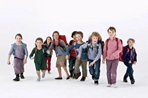 10 11 Years Prints: A group of school kids wearing backpacks and running forward
