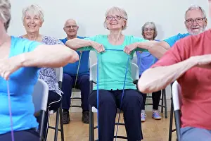 Instructor Prints: Group Of Seniors Using Resistance Bands In Fitness Class