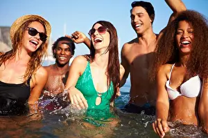 Bikini Prints: Group Of Young Friends Having Fun In Sea Together
