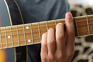 Song Prints: Guitarist male playing acoustic guitar sitting at desk