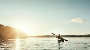 Guy, kayak and boat on lake outdoor for sports adventure or nature travel trip