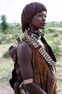 Contact Prints: Hamar tribe woman carrying baby on her back; Ethiopia